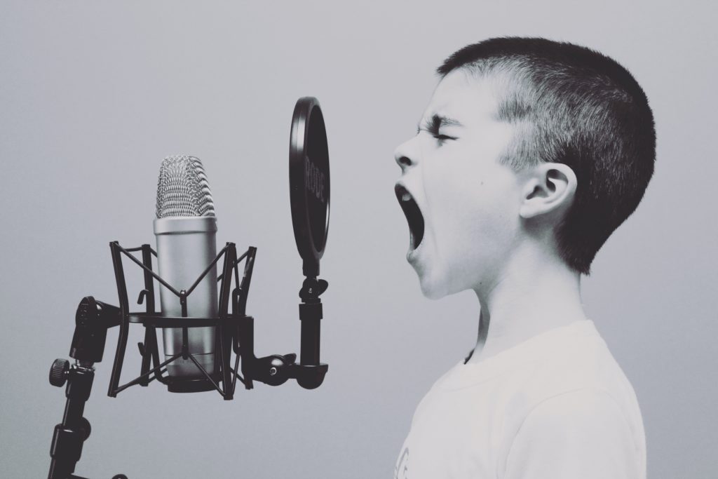 Kid yelling into a microphone